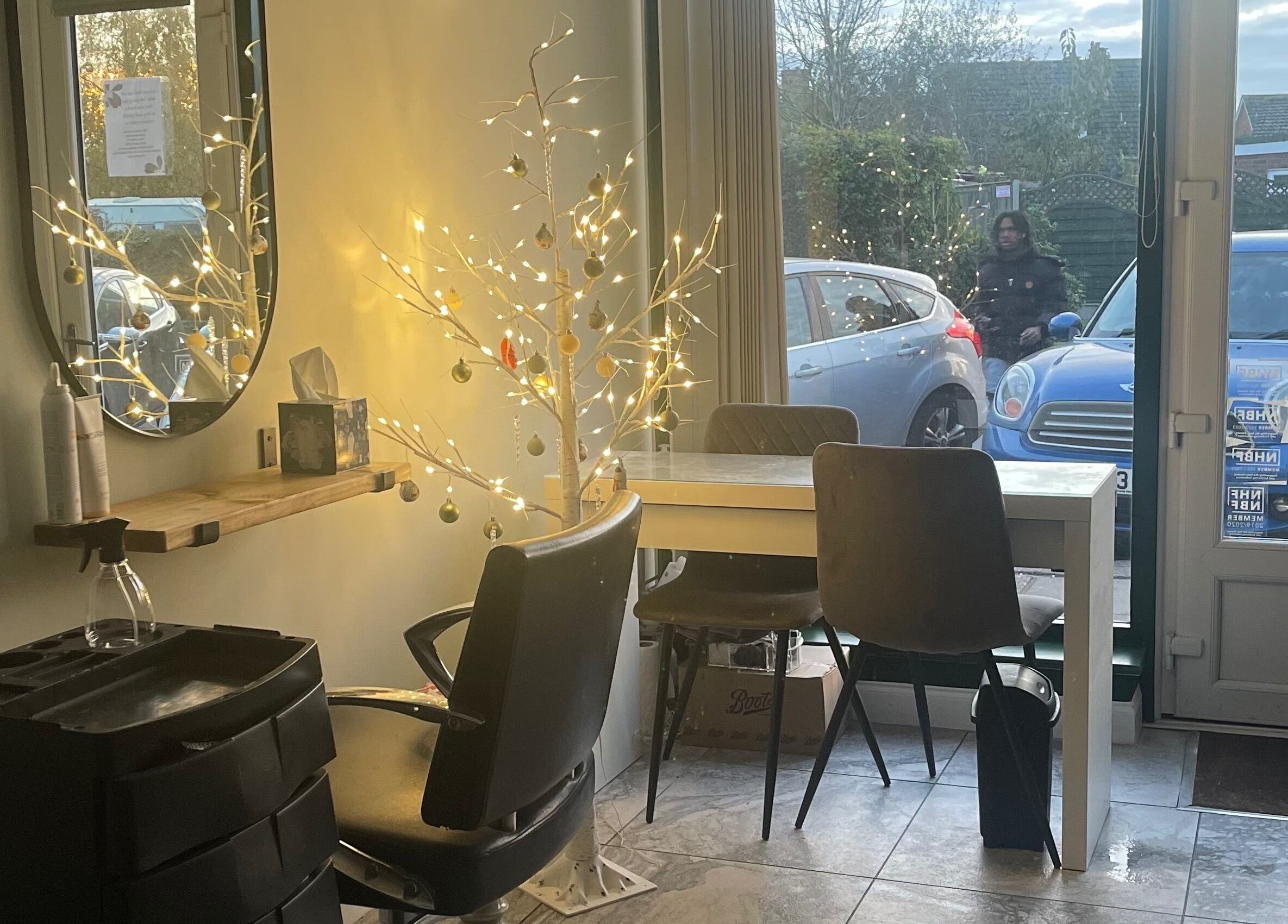 Serene salon interior with festive lights at Salon Seven, Wivenhoe, England, GB.