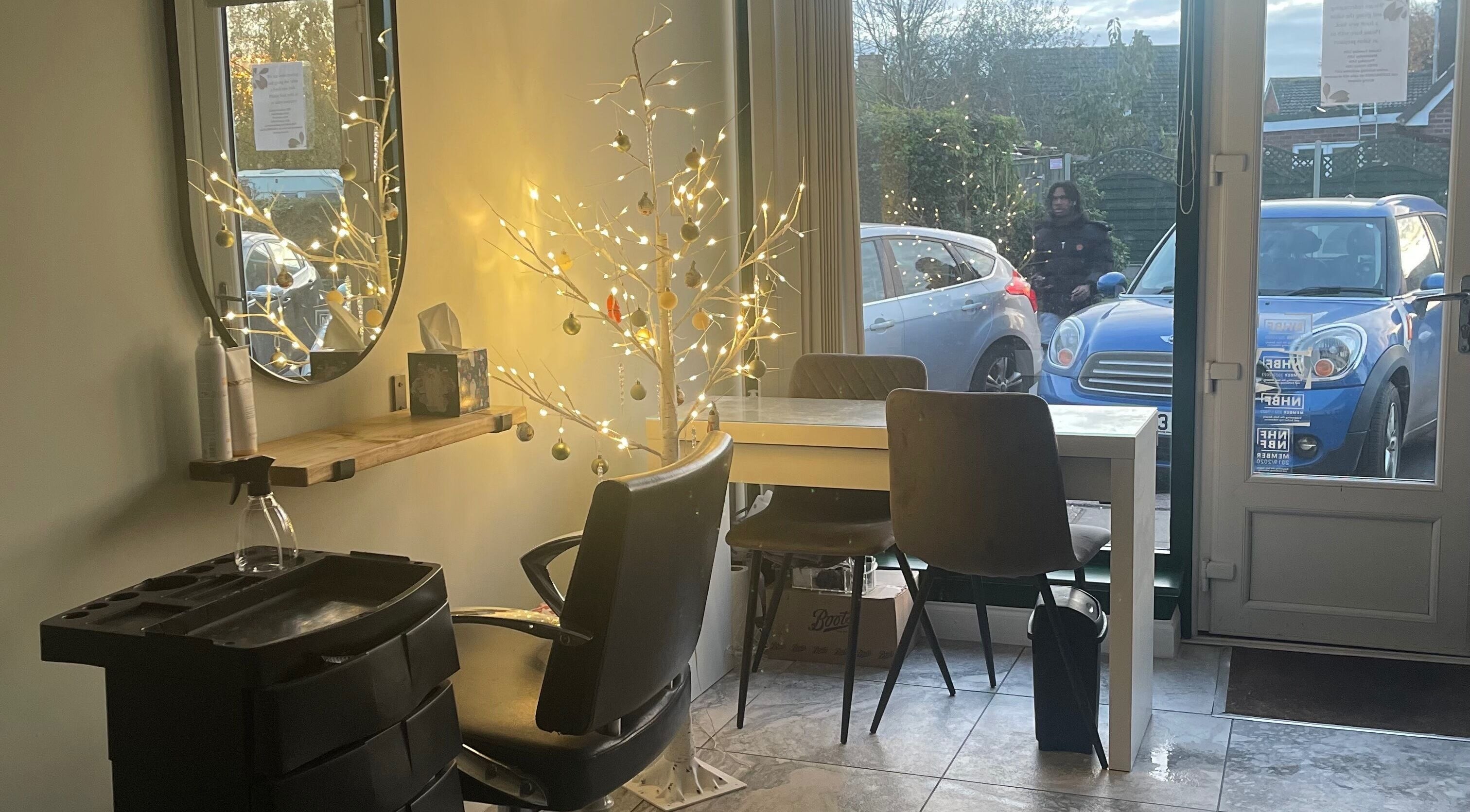 Serene salon interior with festive lights at Salon Seven, Wivenhoe, England, GB.