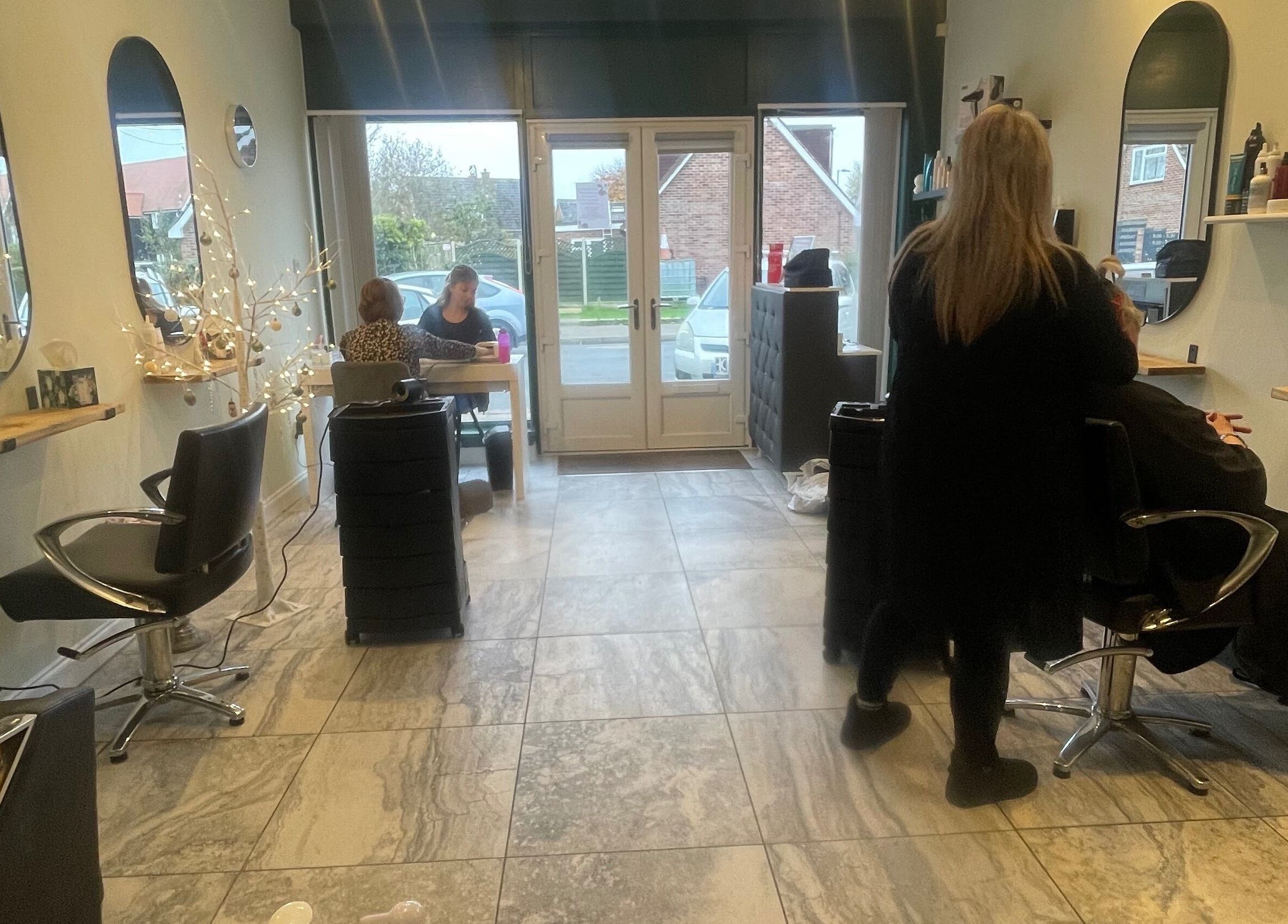 Elegant interior of Salon Seven in Wivenhoe, England, GB showcasing modern styling stations.