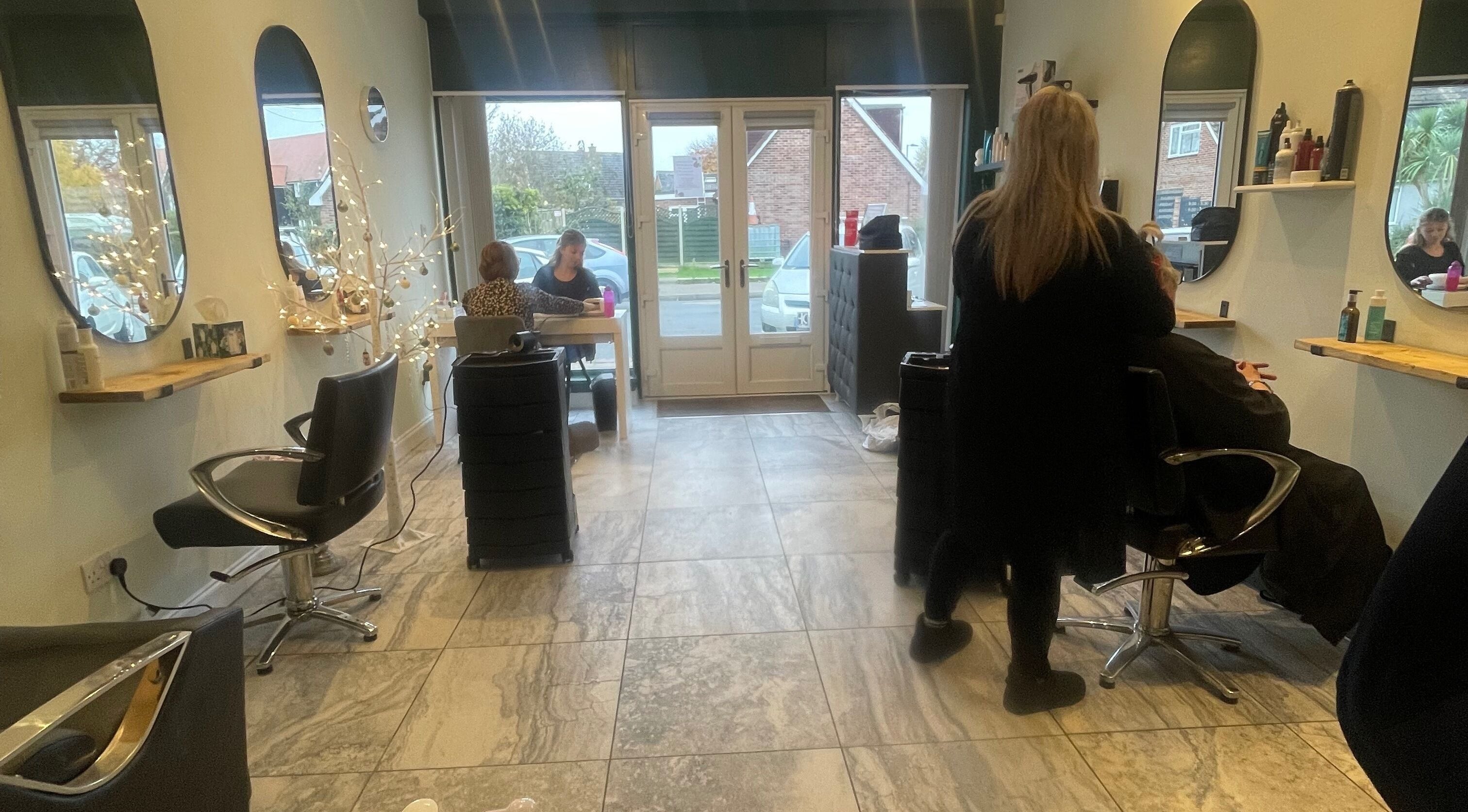 Elegant interior of Salon Seven in Wivenhoe, England, GB showcasing modern styling stations.