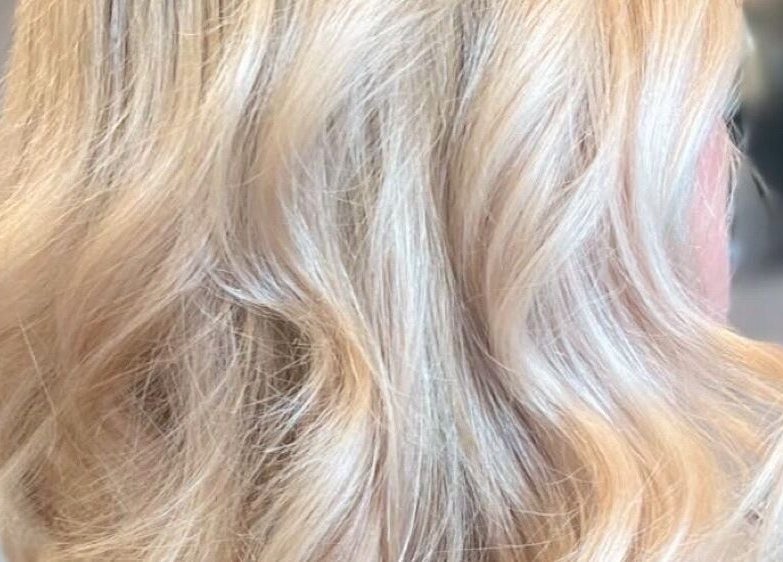 Close-up of wavy blonde hair at Salon Seven in Wivenhoe, England, GB.
