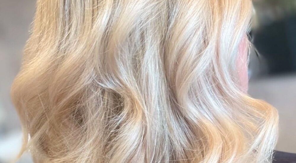 Close-up of wavy blonde hair at Salon Seven in Wivenhoe, England, GB.