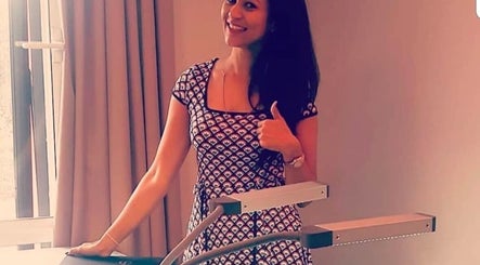 Woman smiling at Dee's Beauty, Chineham, England, GB, showcasing salon's modern equipment.
