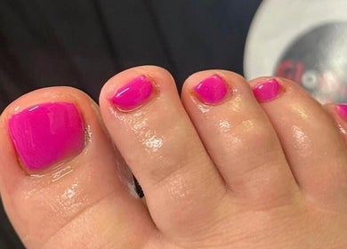 Vibrant pink toenail polish at Gloss & Glo, Paisley, Scotland, GB. Experience premium pedicure services here.