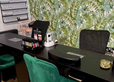 Nail station at Gloss & Glo, Paisley, Scotland, GB with tropical leaf wallpaper and manicure tools.