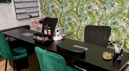 Nail station at Gloss & Glo, Paisley, Scotland, GB with tropical leaf wallpaper and manicure tools.