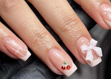 Gloss & Glo in Paisley, Scotland, GB features elegant nail art with bows, gems, and French tips.