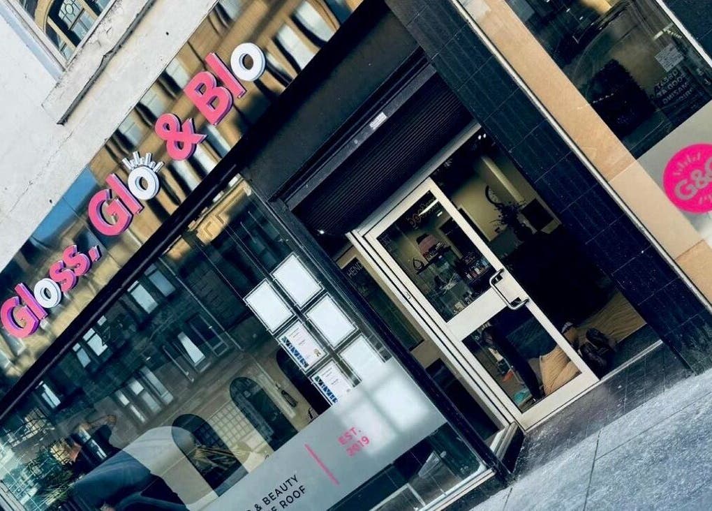 Stylish entrance of Gloss & Glo beauty venue in Paisley, Scotland, GB with modern signage.