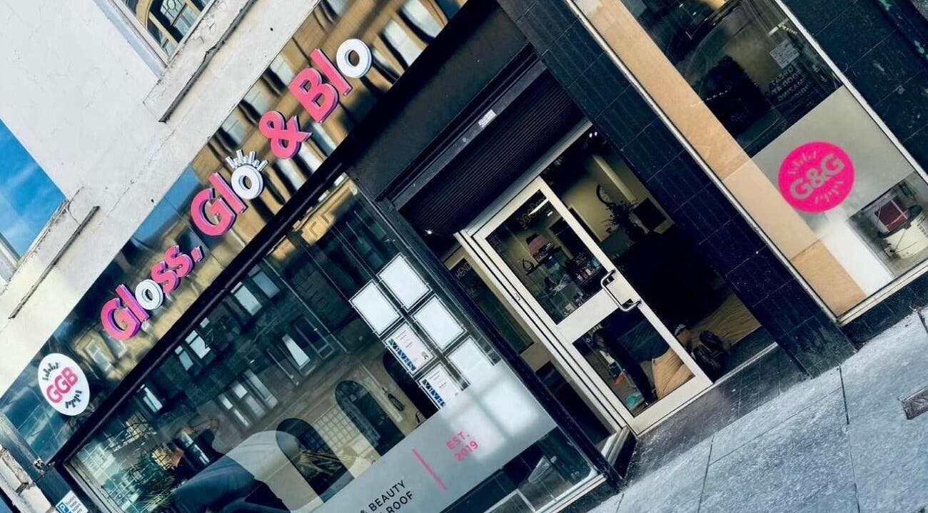 Stylish entrance of Gloss & Glo beauty venue in Paisley, Scotland, GB with modern signage.