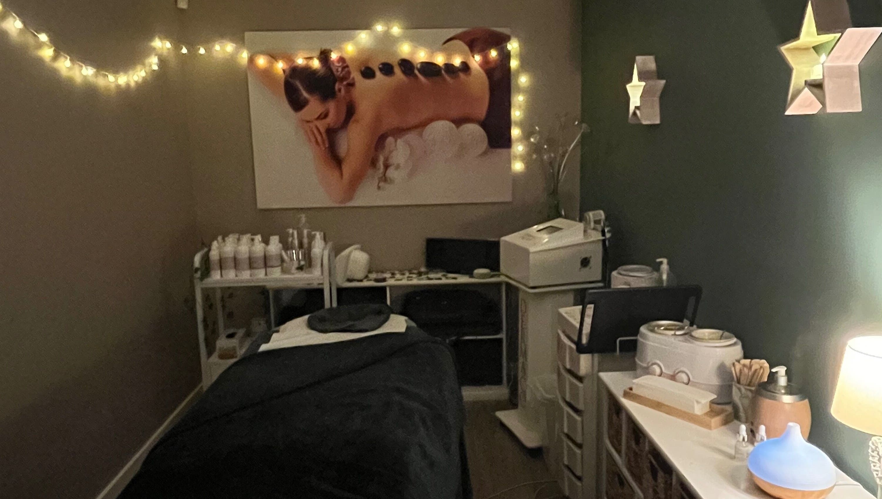 Relaxing treatment room at Midsomer Beauty Salon Ltd, Chilcompton, England, GB with atmospheric lighting and decor.