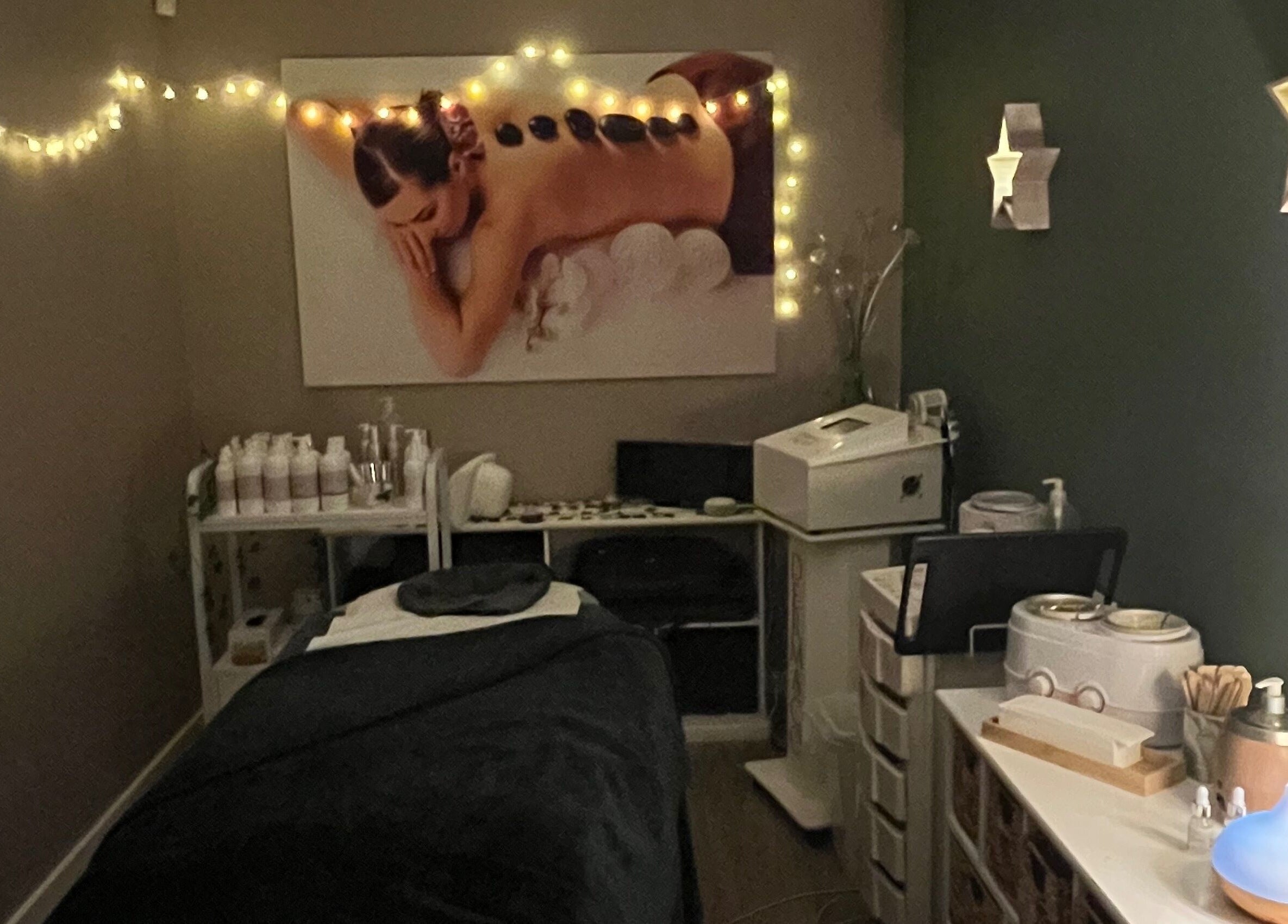 Relaxing treatment room at Midsomer Beauty Salon Ltd, Chilcompton, England, GB with atmospheric lighting and decor.