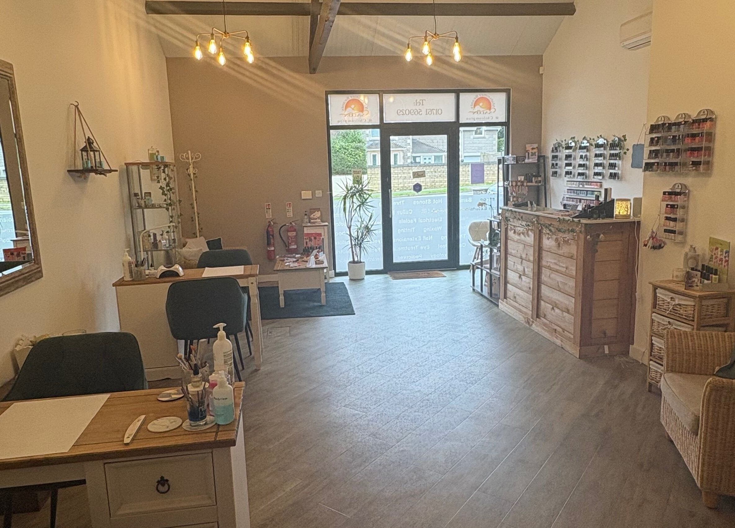 Cozy interior of Midsomer Beauty Salon Ltd in Chilcompton, England, GB with warm lighting and elegant decor.