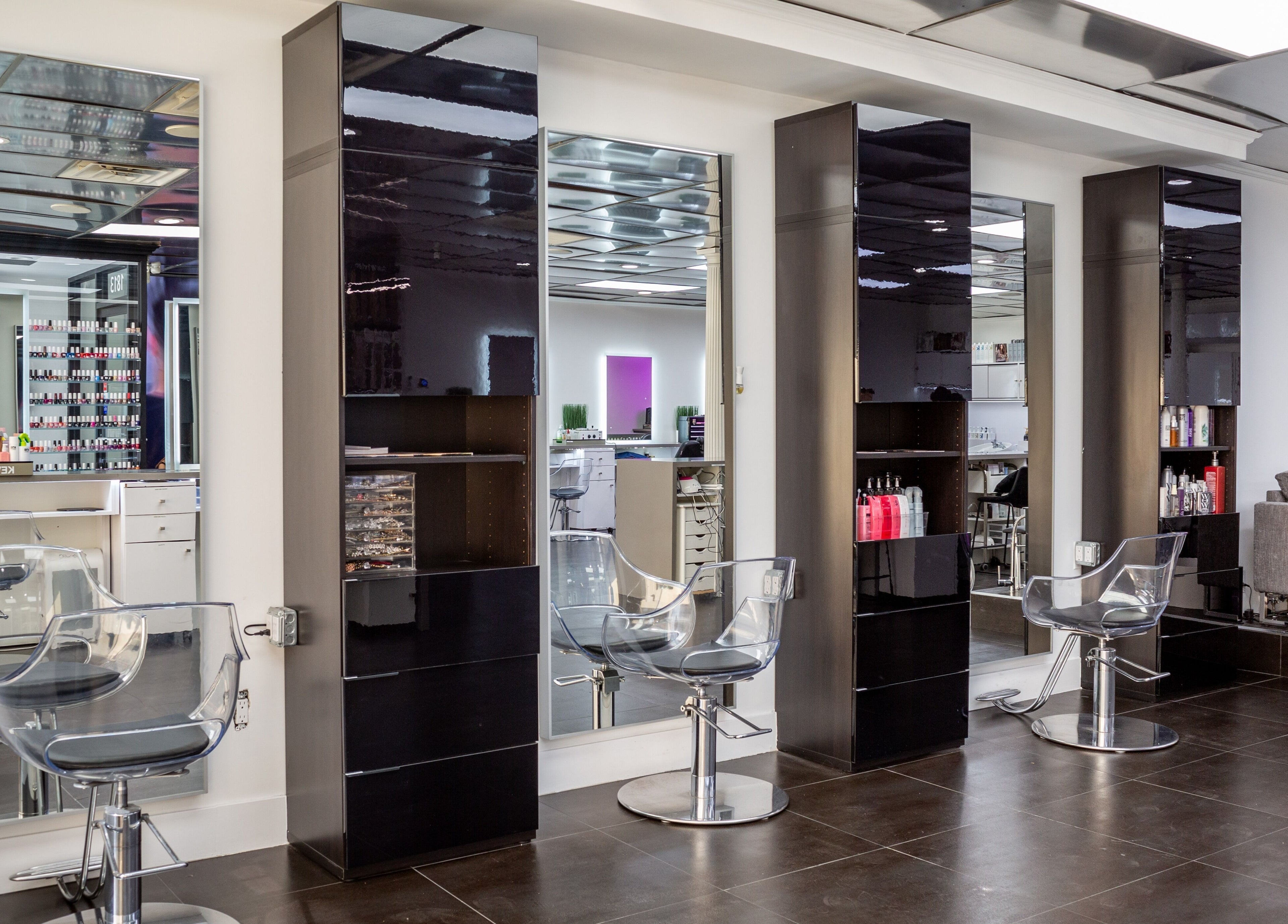 Modern hair styling stations at Salon Creer & Spa in Glendale, California, US, featuring sleek mirrors and chairs.