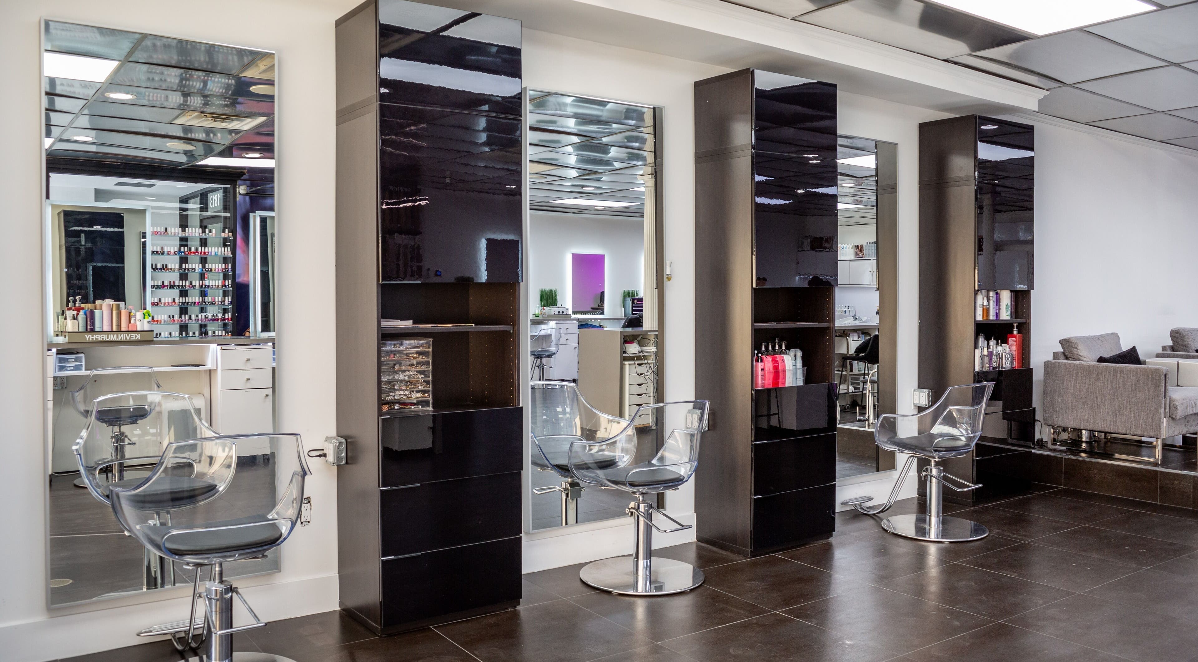 Modern hair styling stations at Salon Creer & Spa in Glendale, California, US, featuring sleek mirrors and chairs.