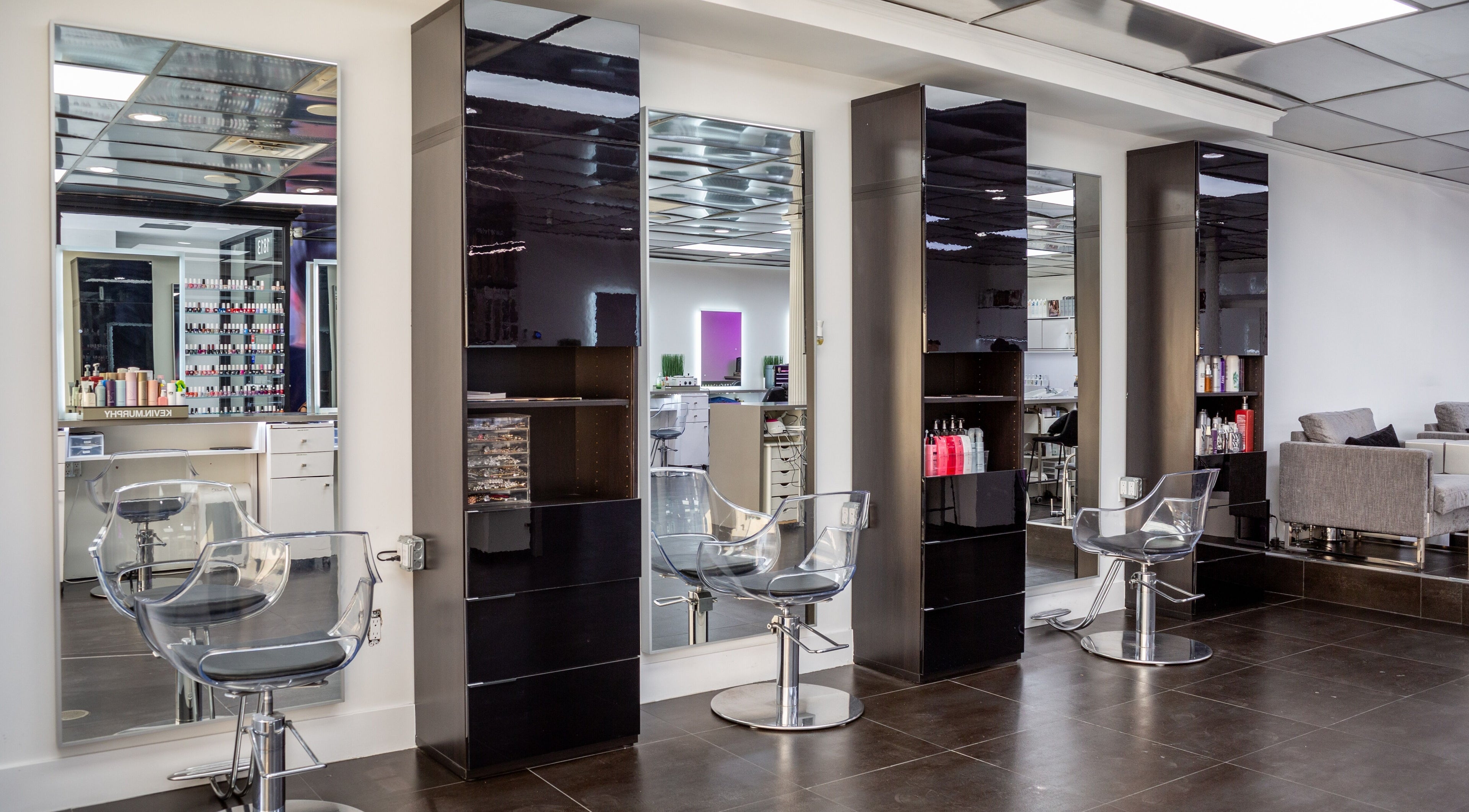 Modern hair styling stations at Salon Creer & Spa in Glendale, California, US, featuring sleek mirrors and chairs.