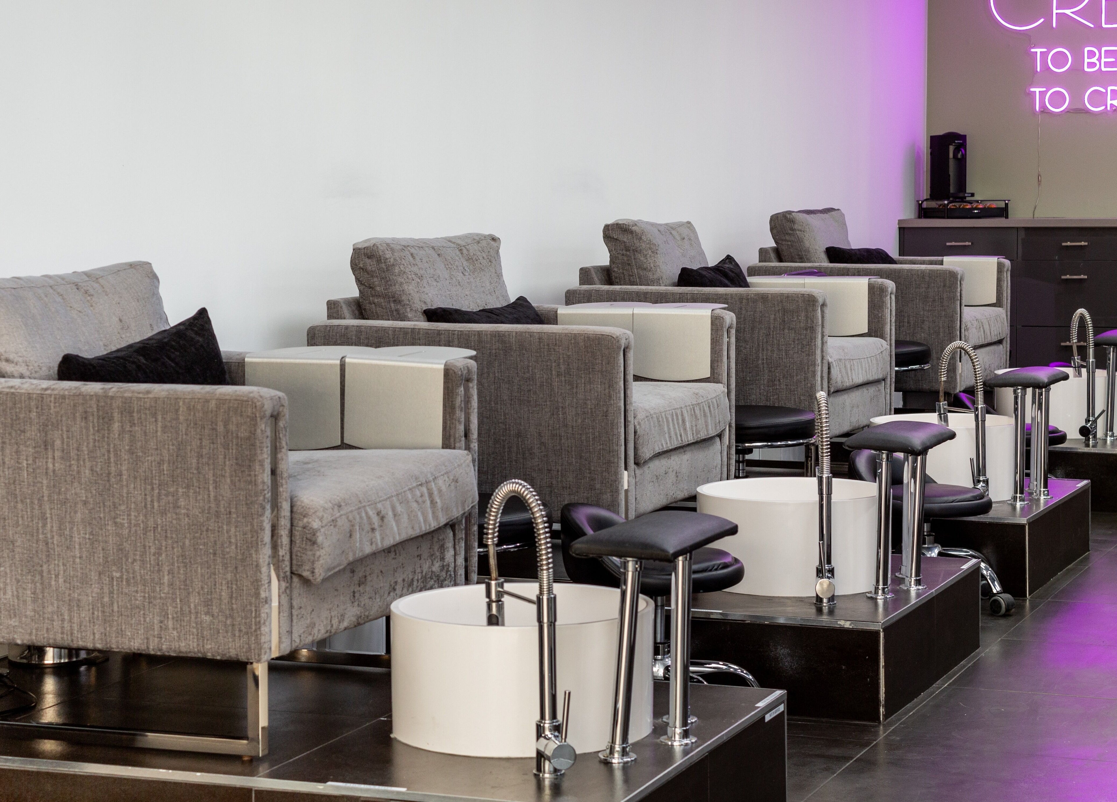 Elegant pedicure chairs at Salon Creer & Spa, Glendale, California, US, under soft neon lighting.