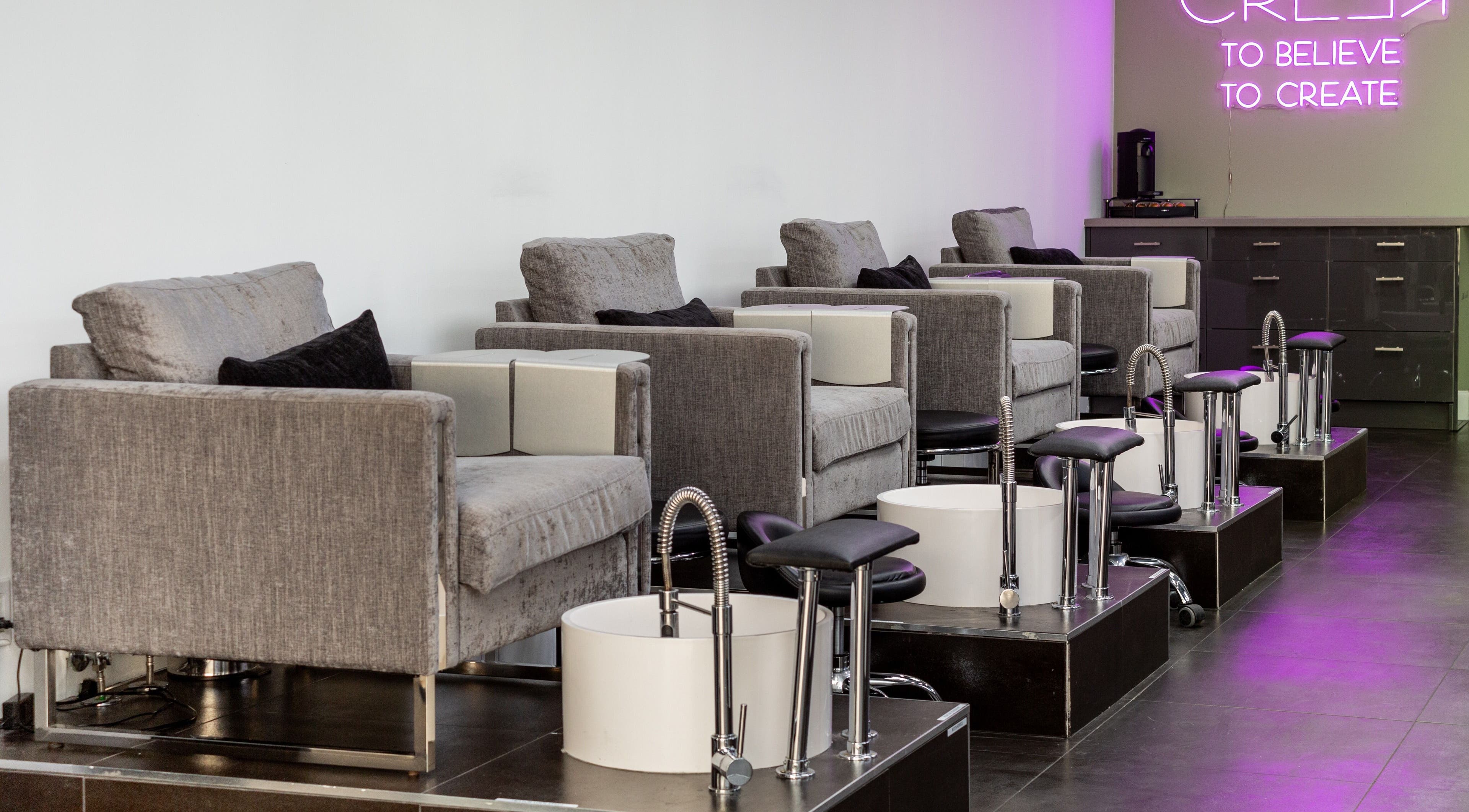 Elegant pedicure chairs at Salon Creer & Spa, Glendale, California, US, under soft neon lighting.