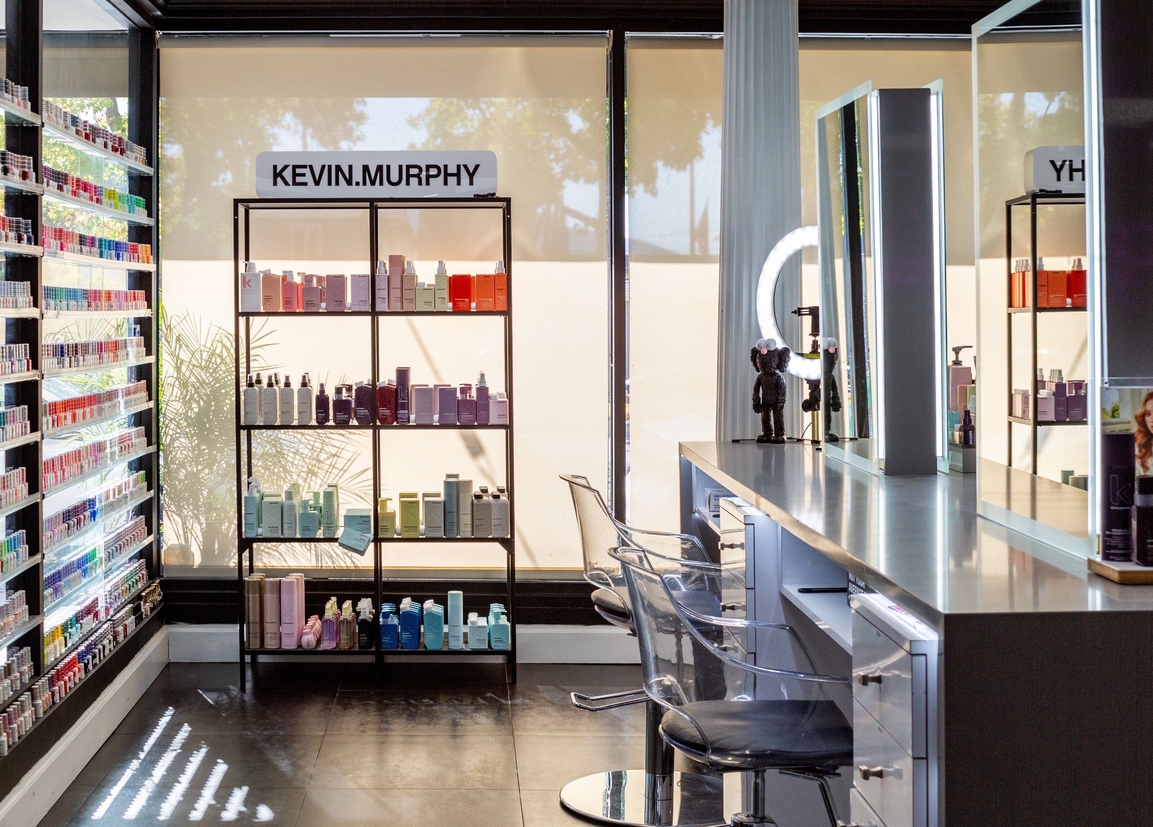 Bright salon interior at Salon Creer & Spa, Glendale, California, US, showcasing beauty products and modern styling stations.