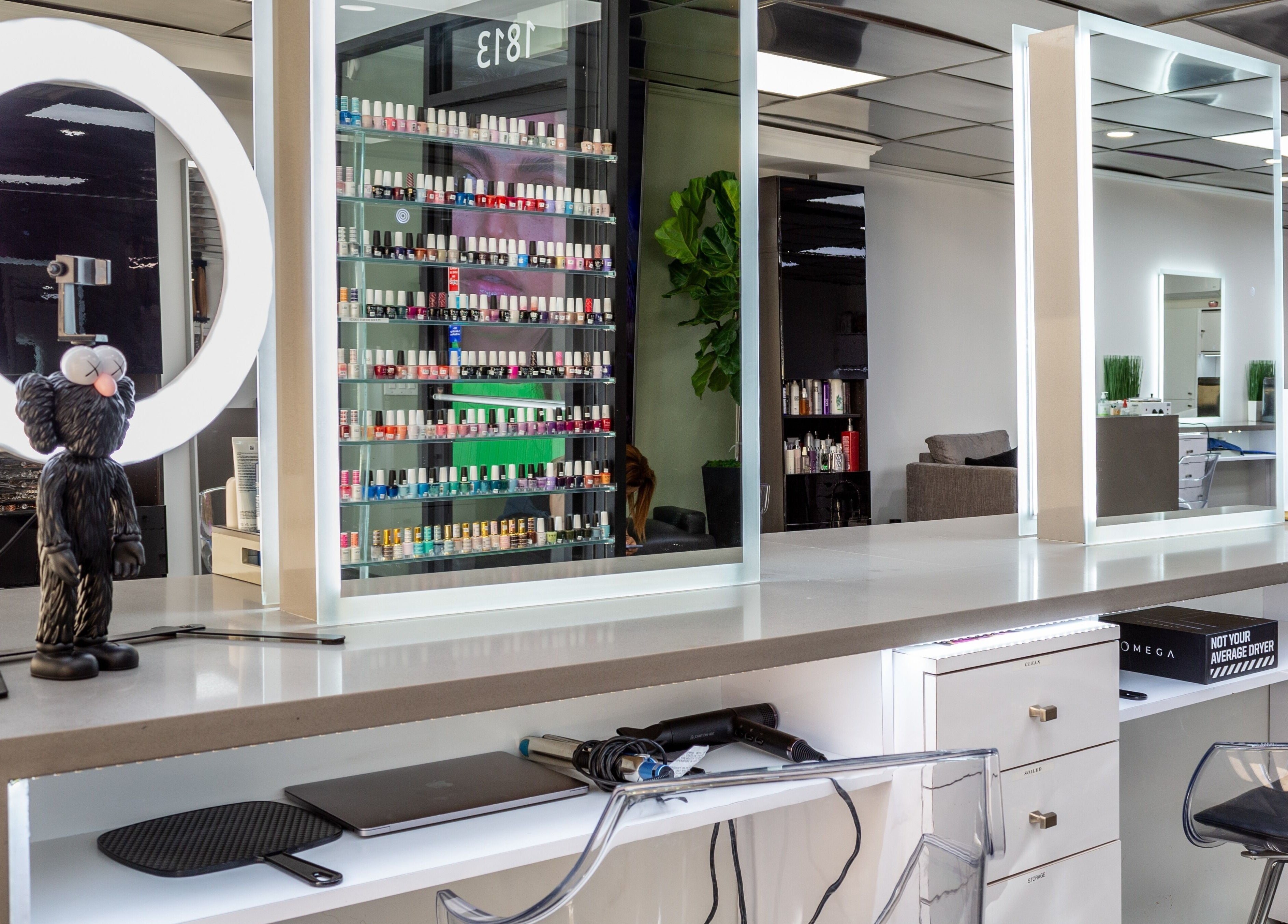 Modern nail service counter at Salon Creer & Spa, Glendale, California, US, showcasing a vibrant polish display.