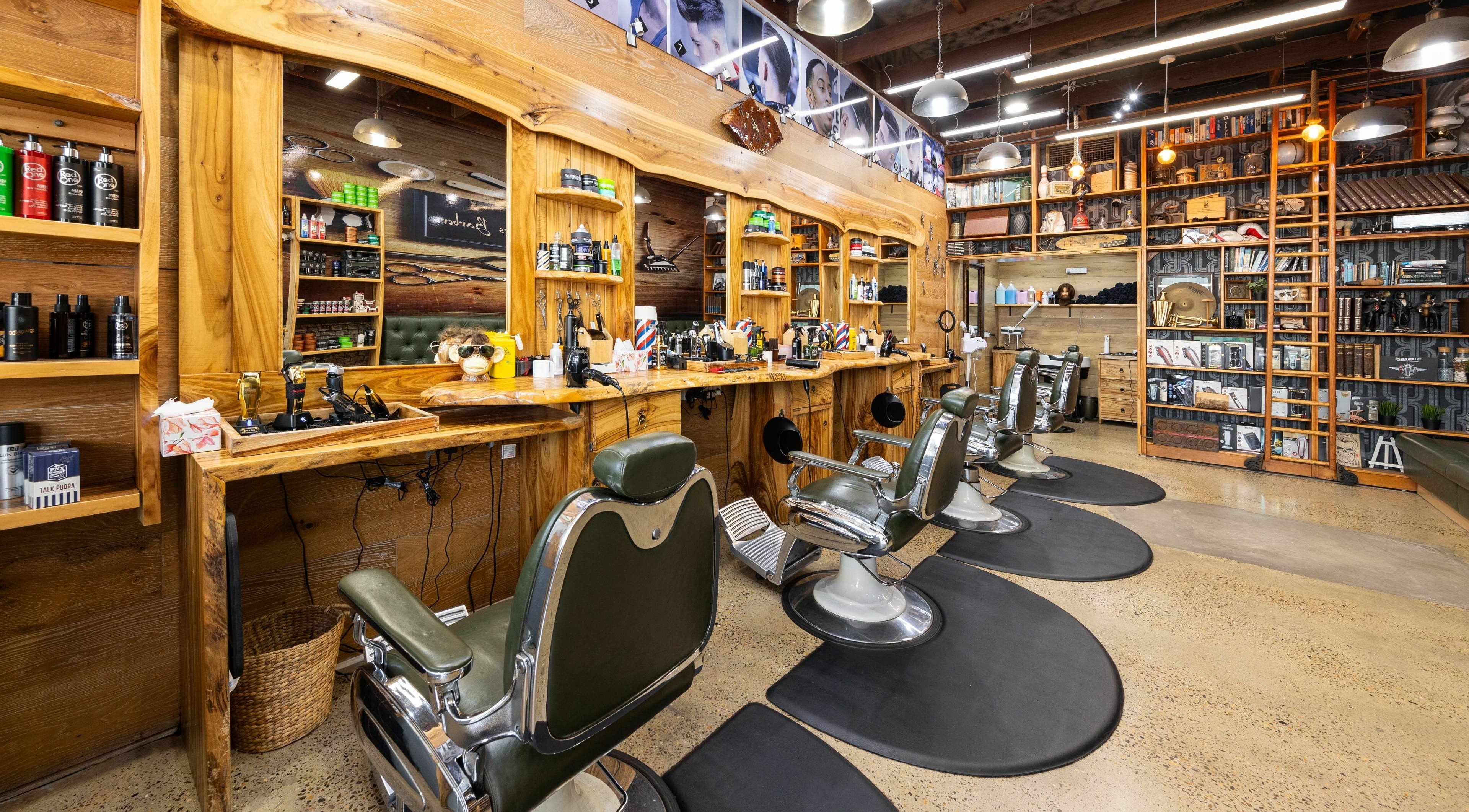 Stylish interior of Ace of Fades Barbers, Surfers Paradise, Queensland, AU with classic chairs and polished wood decor.
