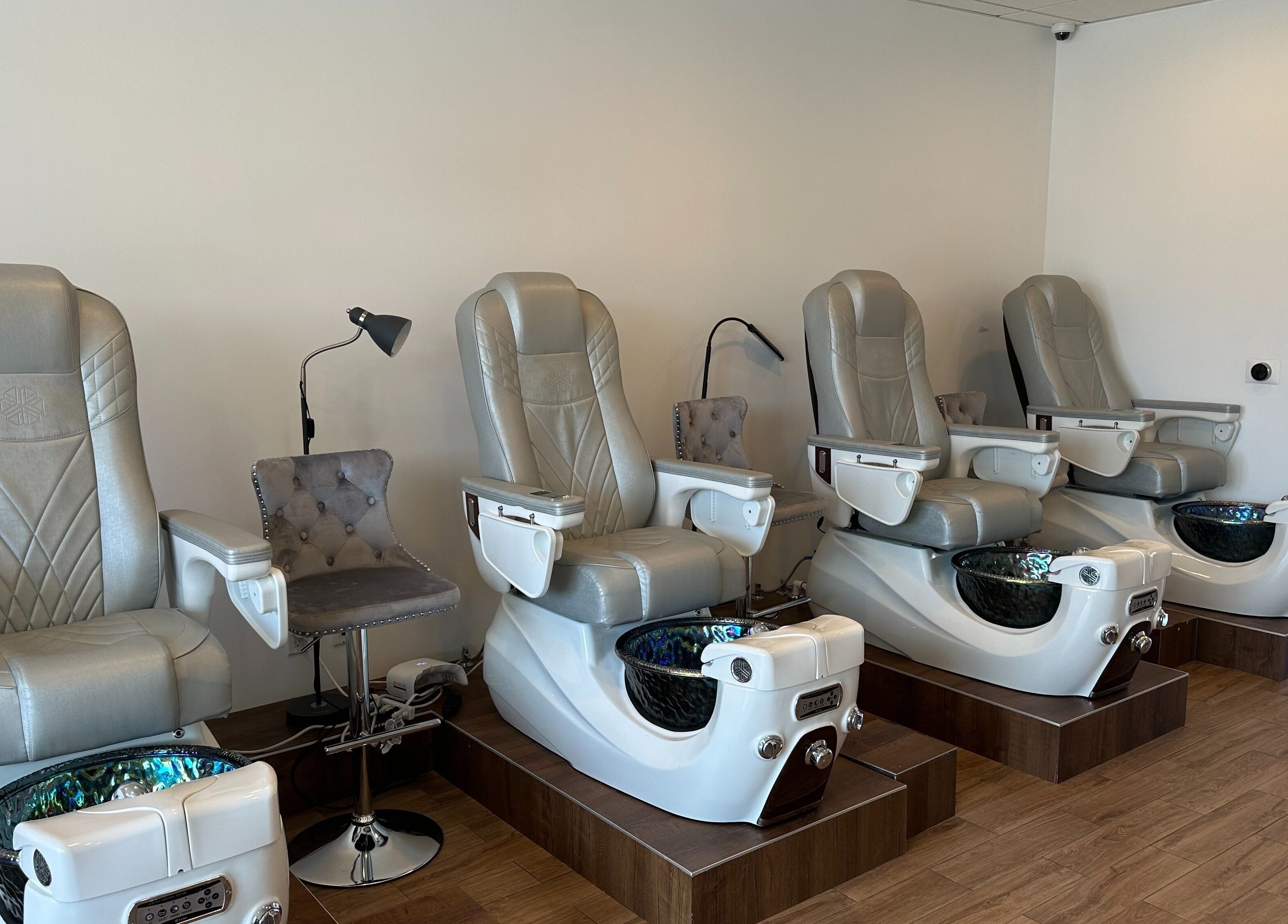 Luxurious pedicure chairs at The Nail Bar, Burbank, California, US showcasing sleek design and comfort.