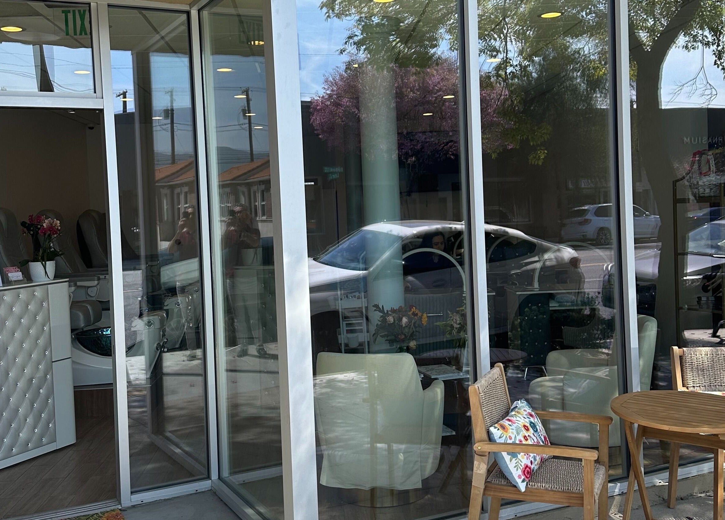 Inviting entrance of The Nail Bar in Burbank, California, US with stylish seating and glass doors.