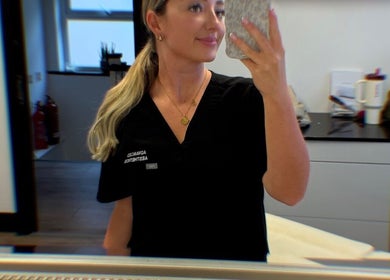 Professional at Advanced Aesthetics, Birkenhead, England, GB posing in modern treatment room.