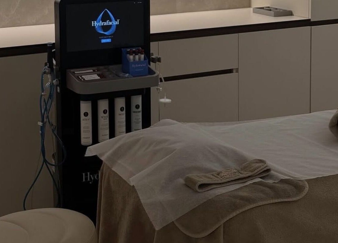 Hydrafacial setup at Advanced Aesthetics, Birkenhead, England, GB. Modern treatment room with equipment and towels.