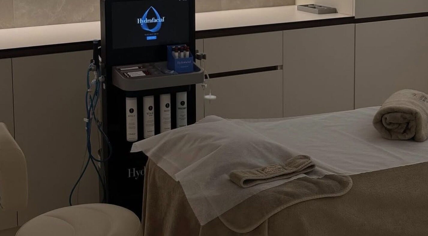 Hydrafacial setup at Advanced Aesthetics, Birkenhead, England, GB. Modern treatment room with equipment and towels.