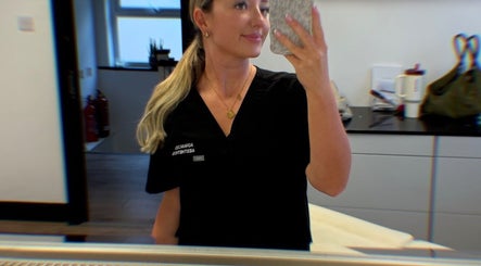 Professional in Advanced Aesthetics uniform smiling at Advanced Aesthetics, Birkenhead, England, GB.