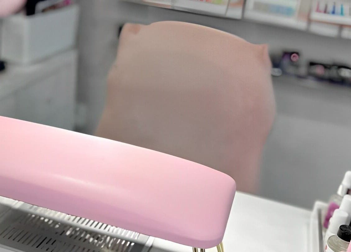 Pink manicure station at Kaycie Kyle Brislington Salon in Bristol, England, GB, featuring stylish nail products.