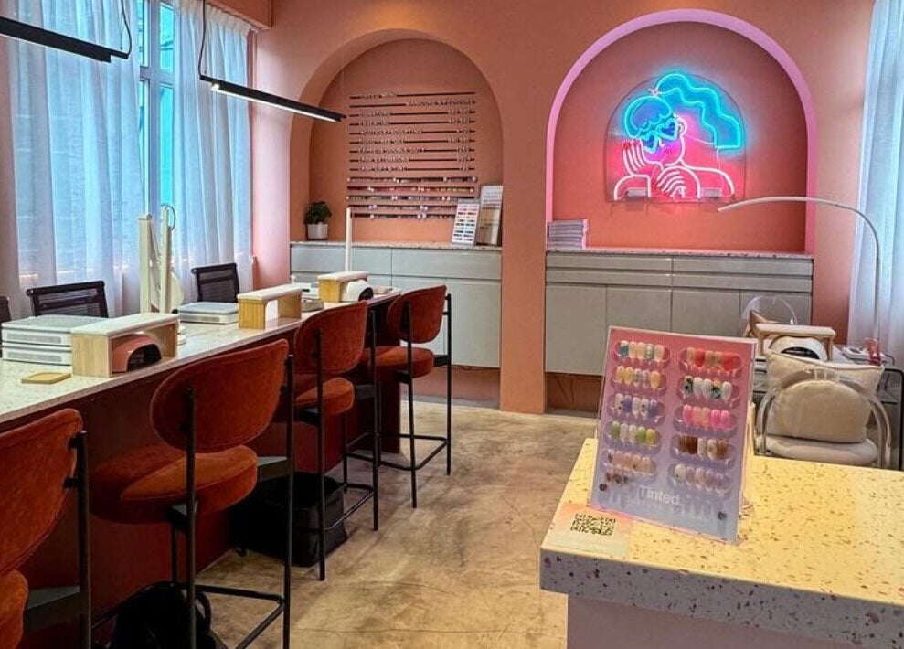 Modern salon interior at Tinted. - Causeway Bay, Hong Kong Island, HK, with pink hues and neon art.