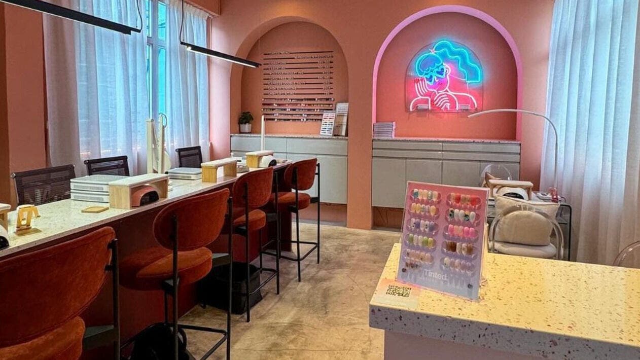 Modern salon interior at Tinted. - Causeway Bay, Hong Kong Island, HK, with pink hues and neon art.