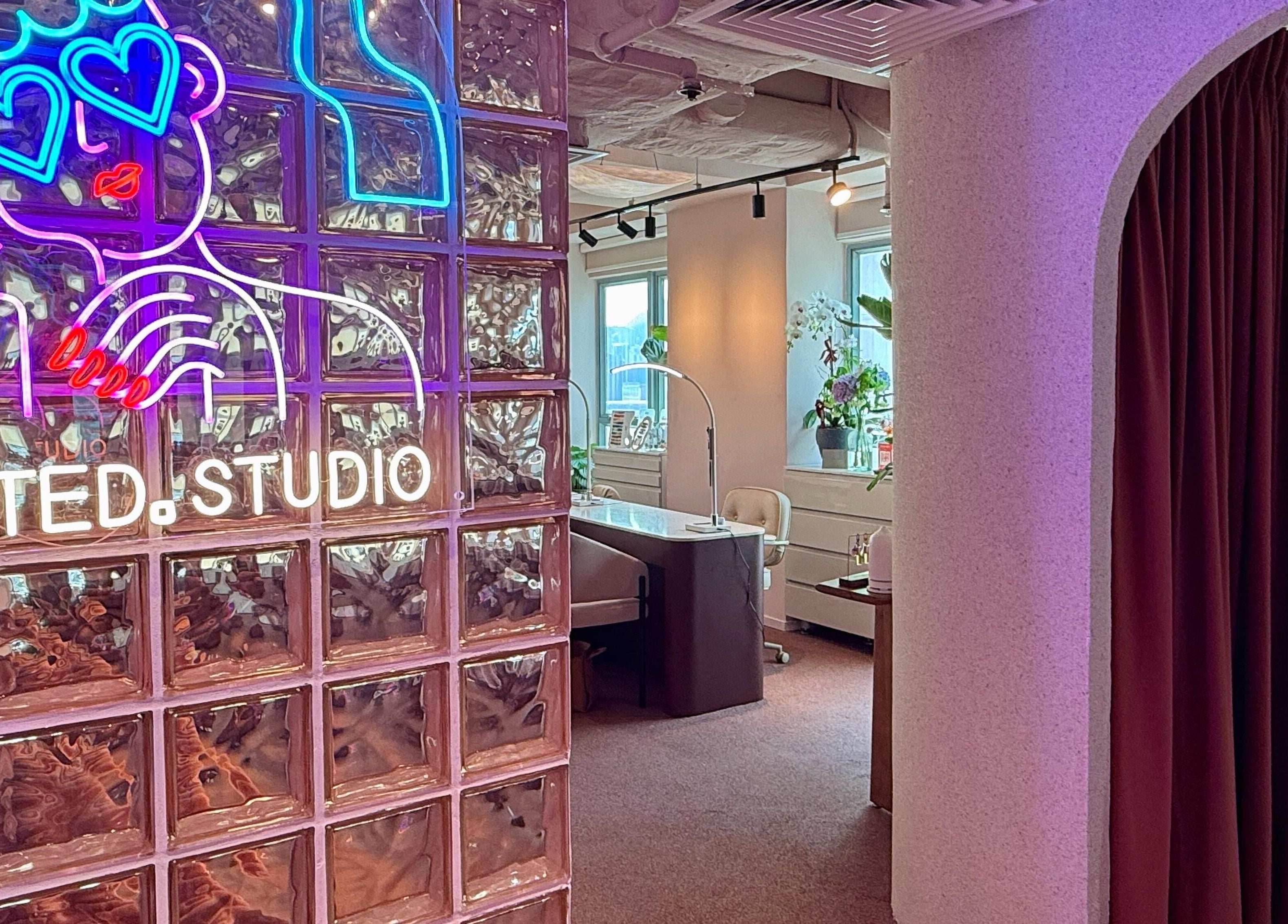 Stylish interior of Tinted. Studio - Tsim Sha Tsui in Kowloon, Kowloon, HK featuring neon wall art and elegant decor.