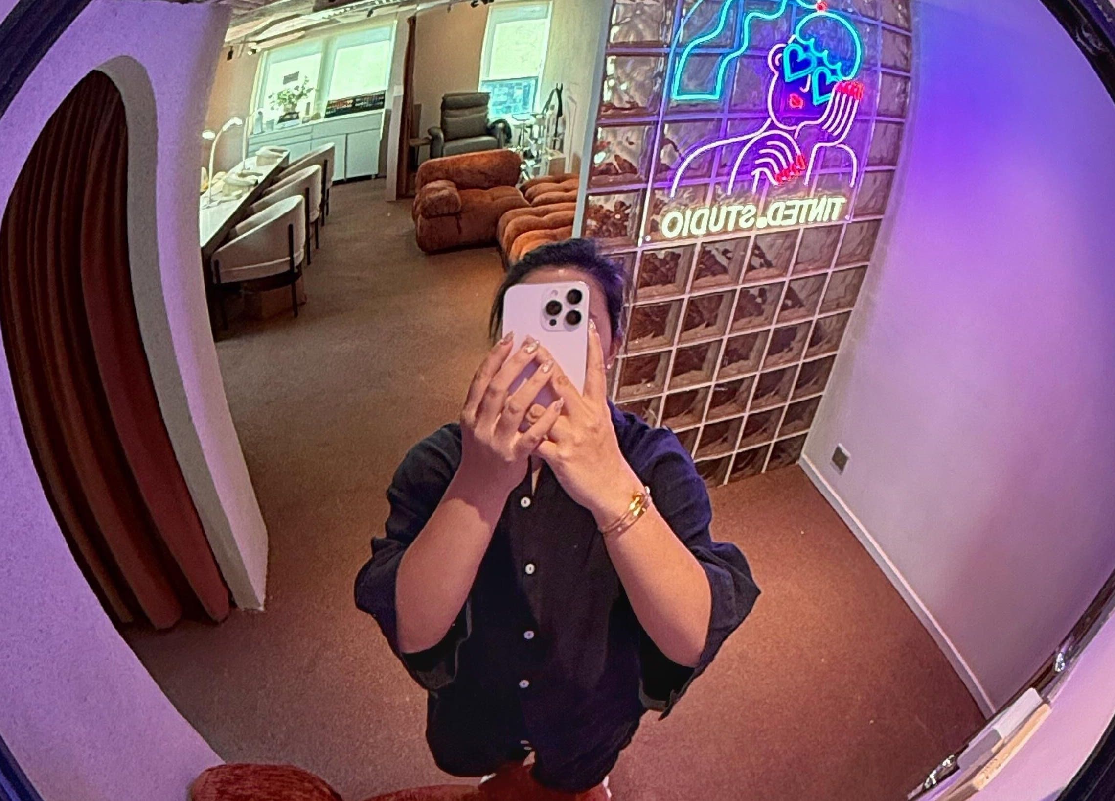 Modern interior at Tinted. Studio - Tsim Sha Tsui with vibrant neon sign in Kowloon, Kowloon, HK.