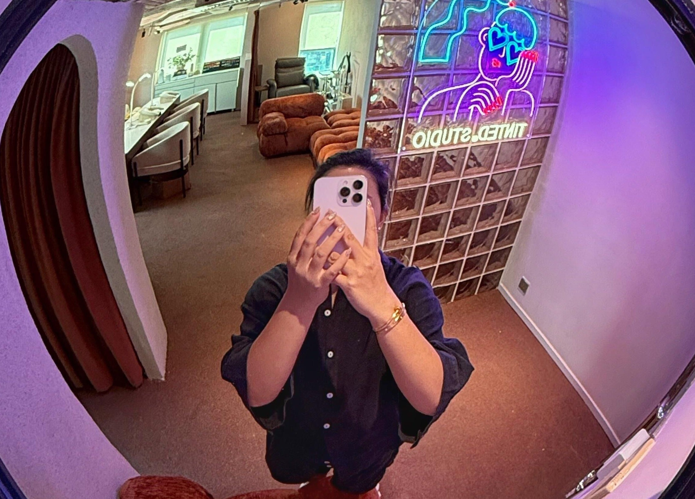 Modern interior at Tinted. Studio - Tsim Sha Tsui with vibrant neon sign in Kowloon, Kowloon, HK.