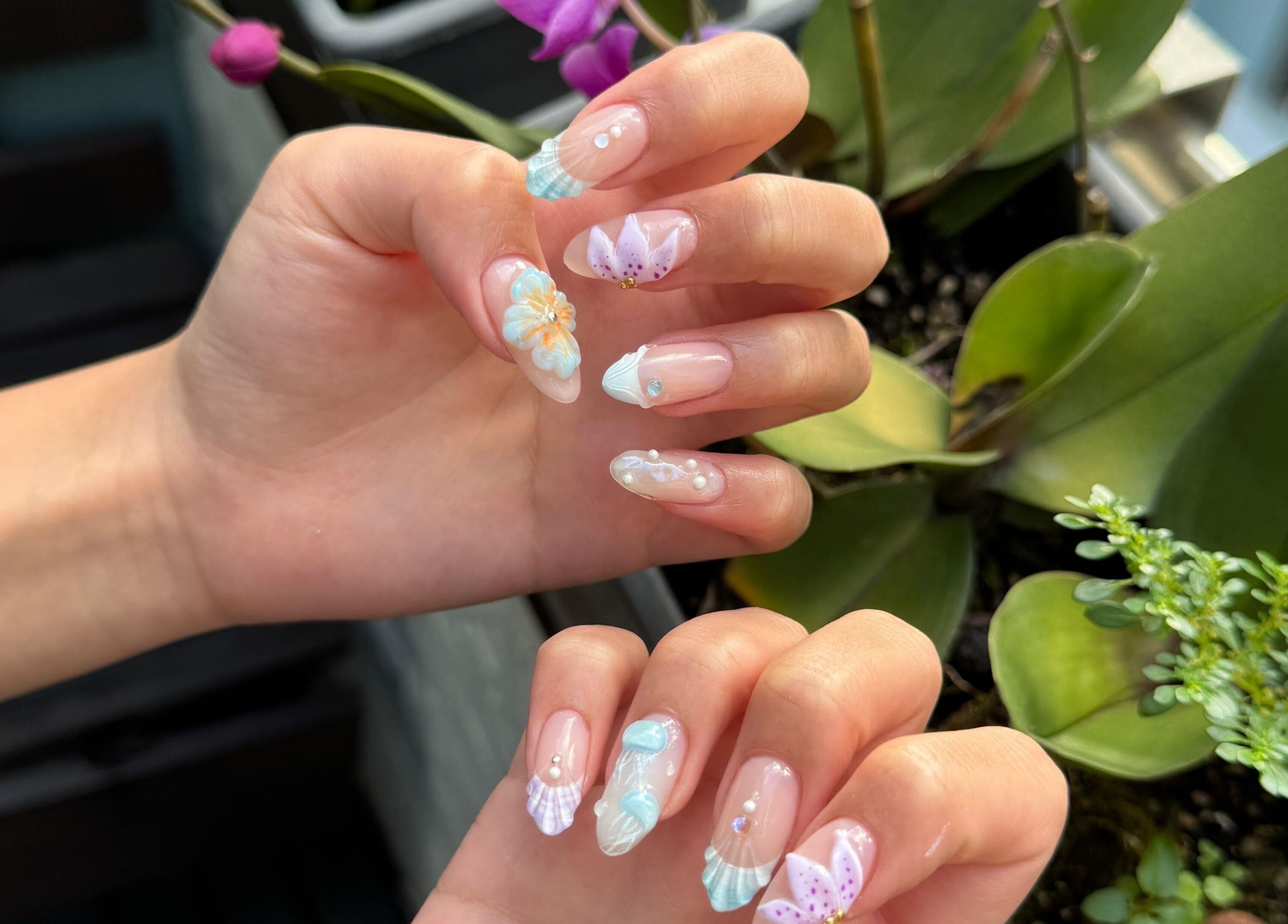 Elegant floral nail art from Tinted. Studio - Tsim Sha Tsui, Kowloon, Kowloon, HK amid natural greens.