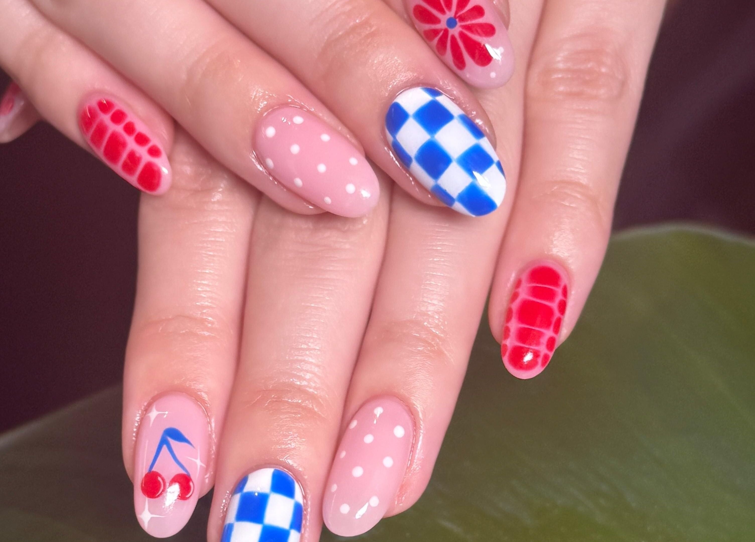 Vibrant nail art featuring red and blue patterns at Tinted. Studio - Tsim Sha Tsui, Kowloon, Kowloon, HK.