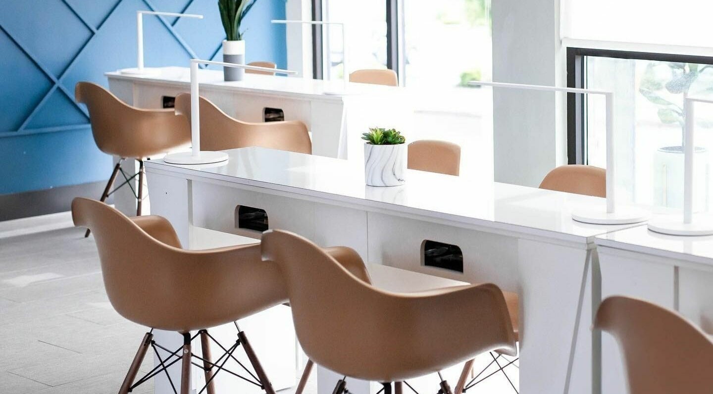 Modern seating area at Nirvana Beauty Lounge, Reno, Nevada, US with stylish chairs and elegant decor.