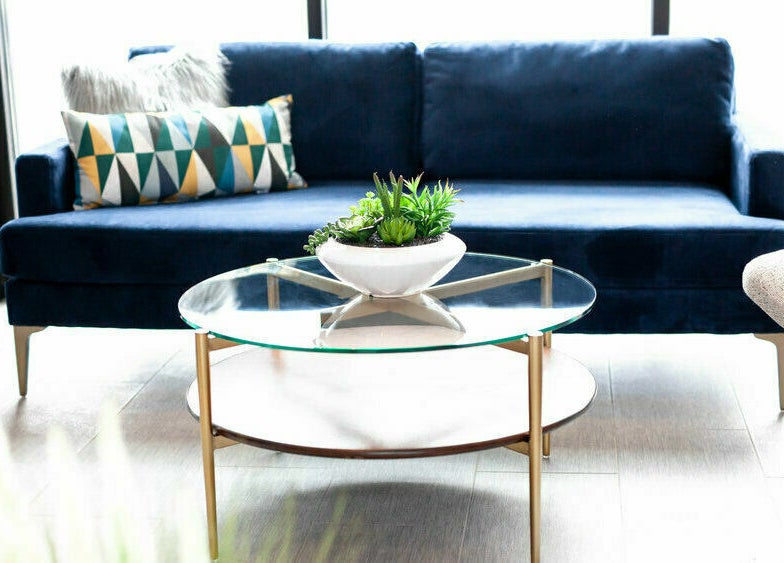 Stylish seating area at Nirvana Beauty Lounge in Reno, Nevada, US with plush sofa and glass table.