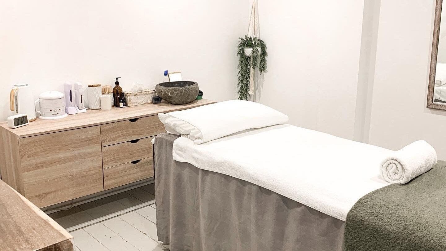 Tranquil treatment room at Oura Day Spa, Gisborne, NZ with a massage table and calming decor.