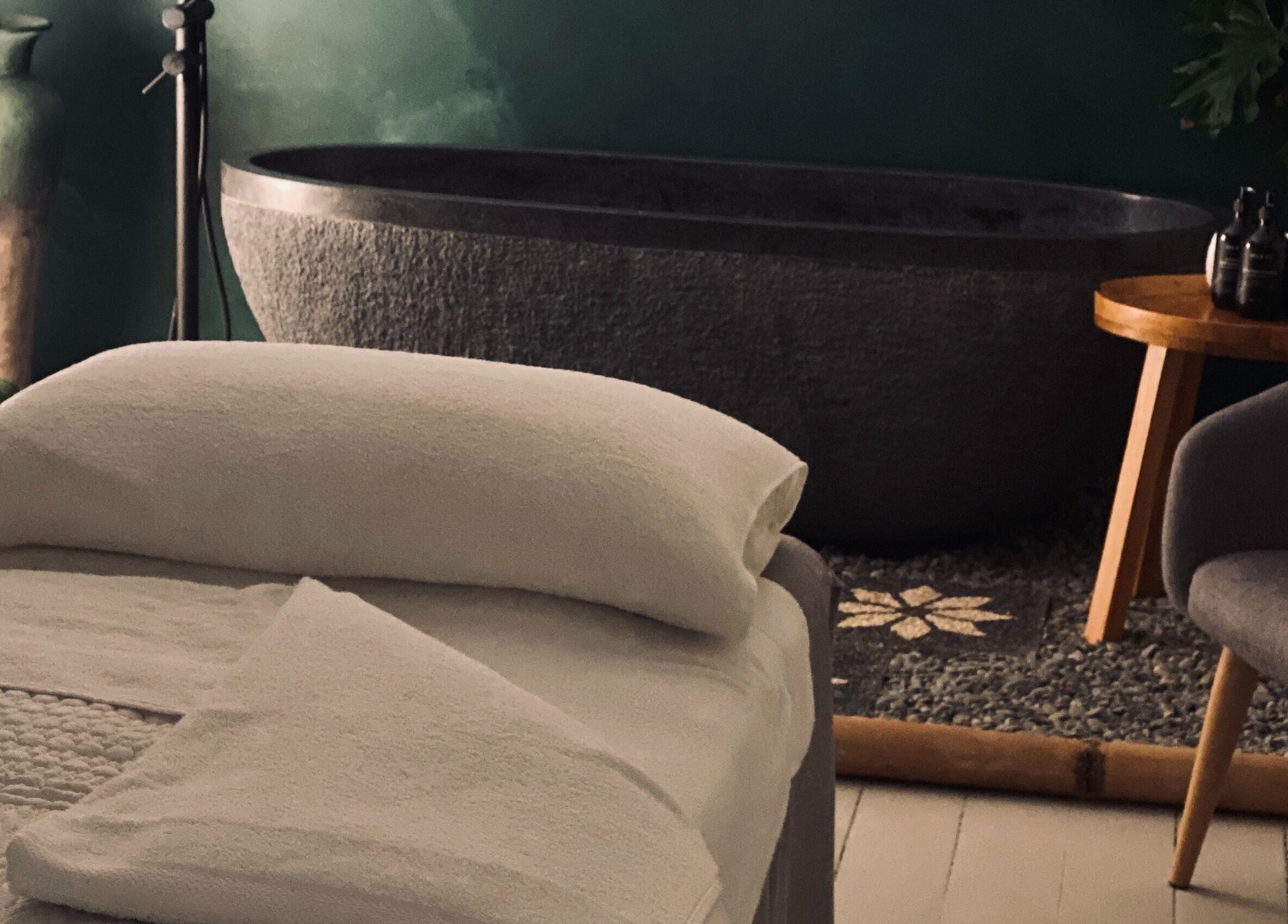 Luxurious treatment room at Oura Day Spa, Gisborne, Gisborne, NZ features a plush bed and tranquil ambiance.