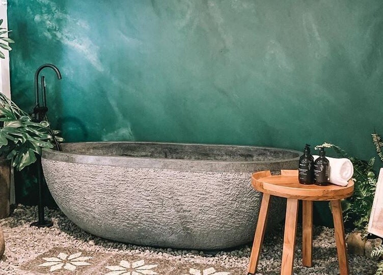 Tranquil bath setup at Oura Day Spa, Gisborne, Gisborne, NZ amidst lush greenery.