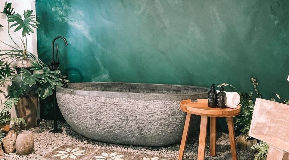 Tranquil bath setup at Oura Day Spa, Gisborne, Gisborne, NZ amidst lush greenery.
