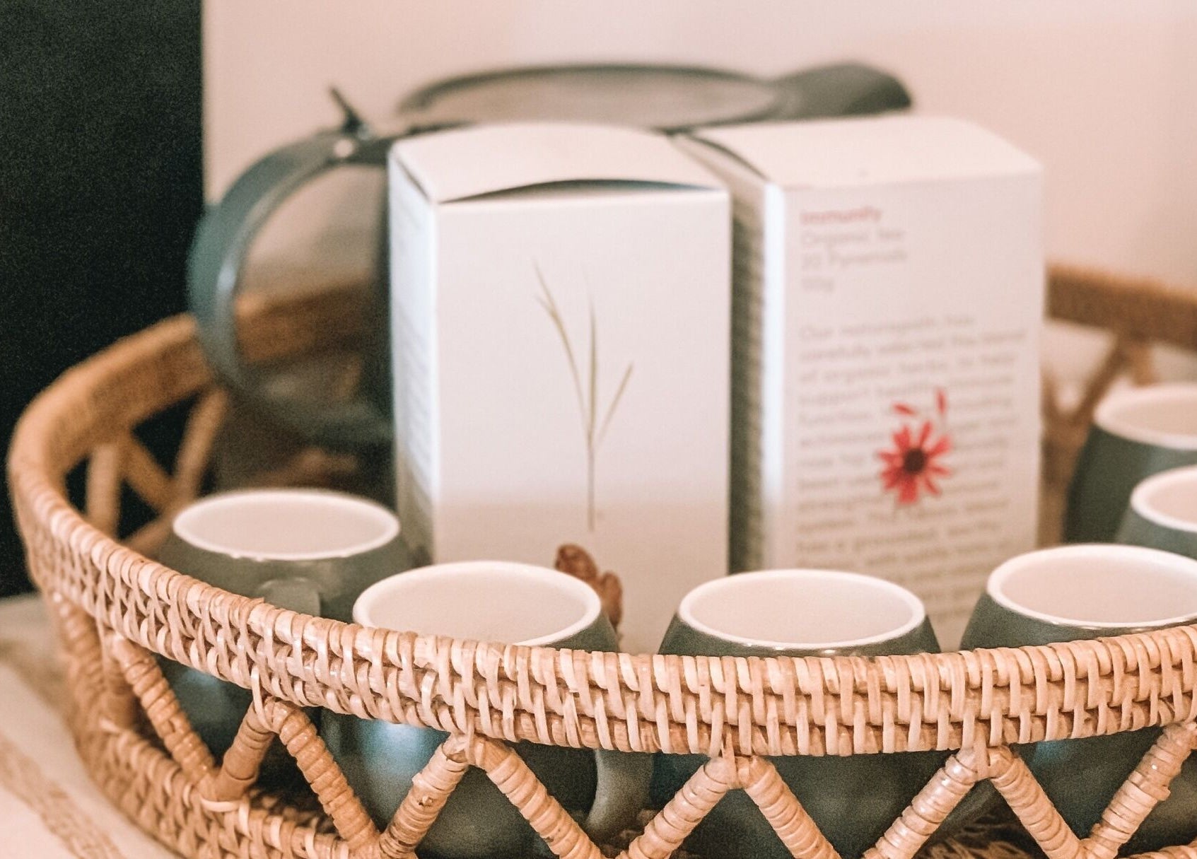 Cozy tea setup in wicker tray at Oura Day Spa, Gisborne, NZ, enhancing relaxation and wellness atmosphere.
