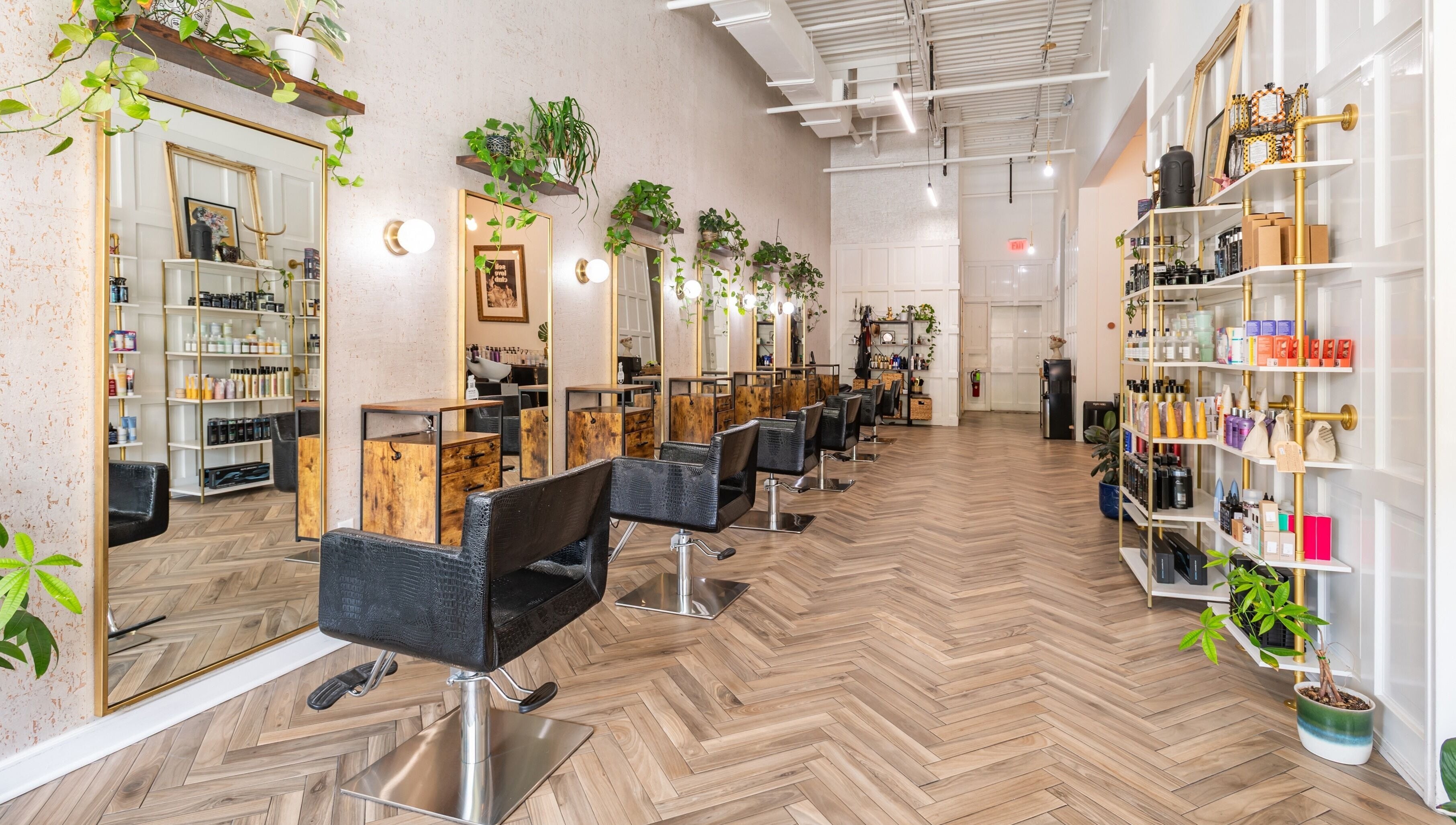 Interior of The Alma Project by AG in Boca Raton, Florida, US, featuring chic salon chairs and vibrant decor.