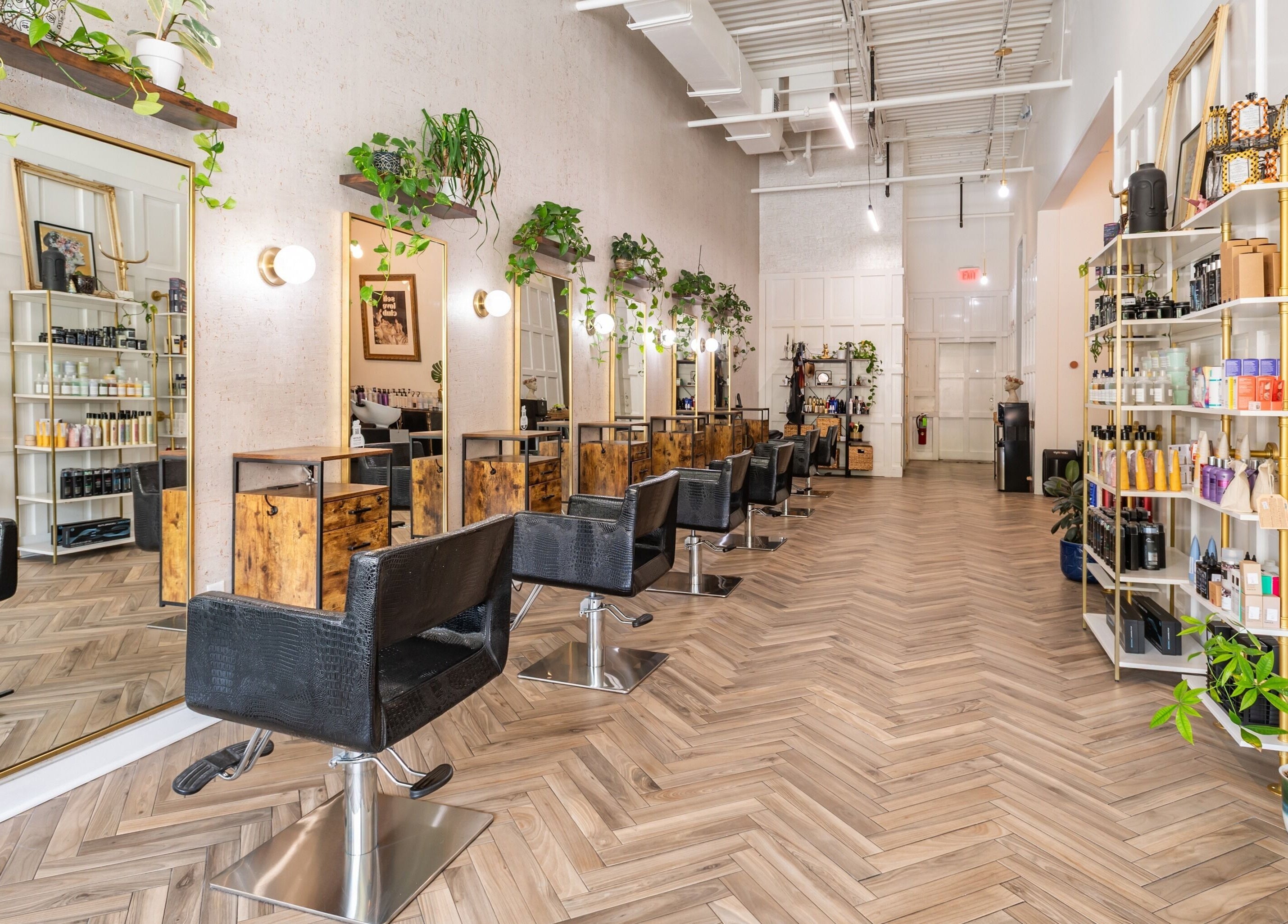 Interior of The Alma Project by AG in Boca Raton, Florida, US, featuring chic salon chairs and vibrant decor.