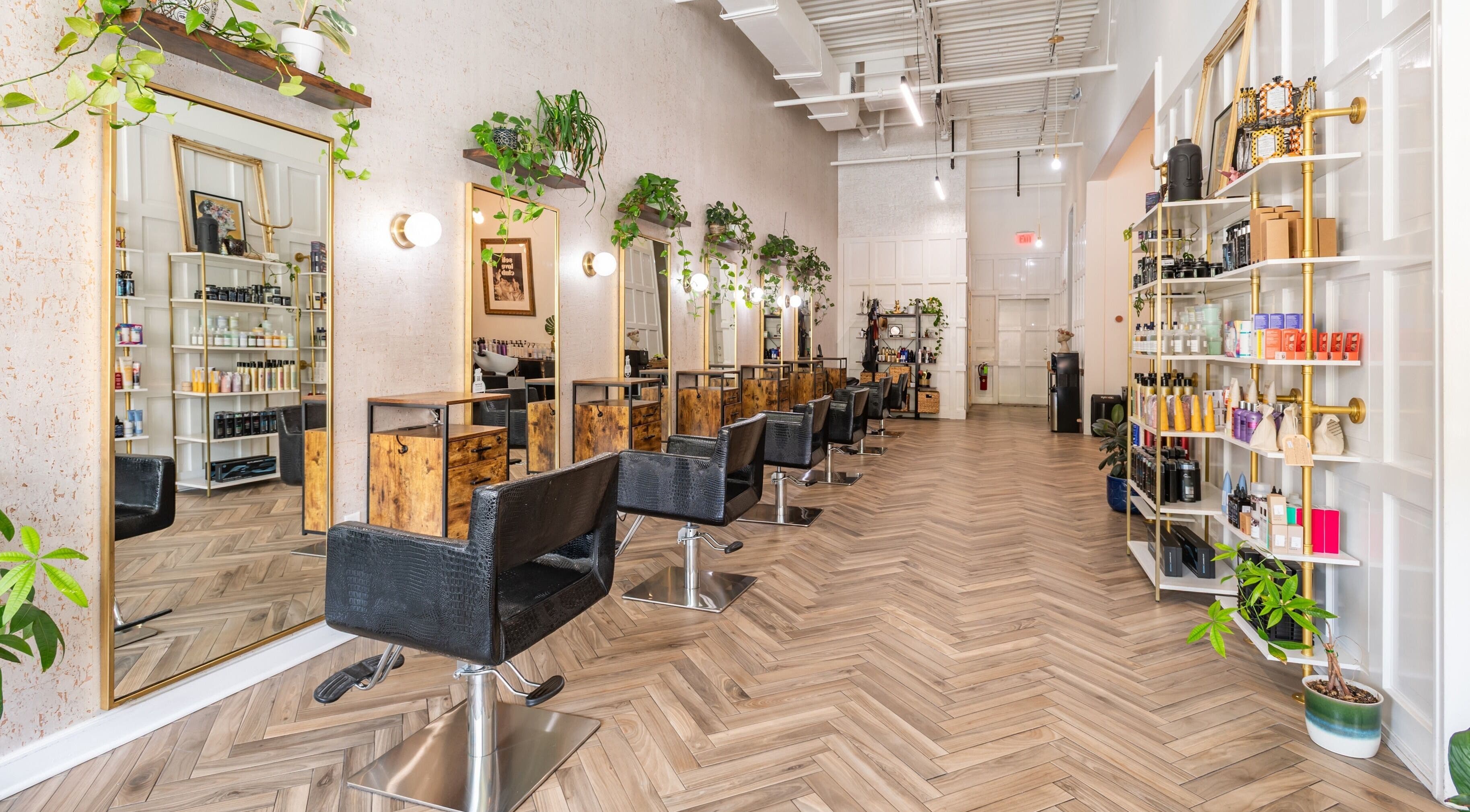 Interior of The Alma Project by AG in Boca Raton, Florida, US, featuring chic salon chairs and vibrant decor.