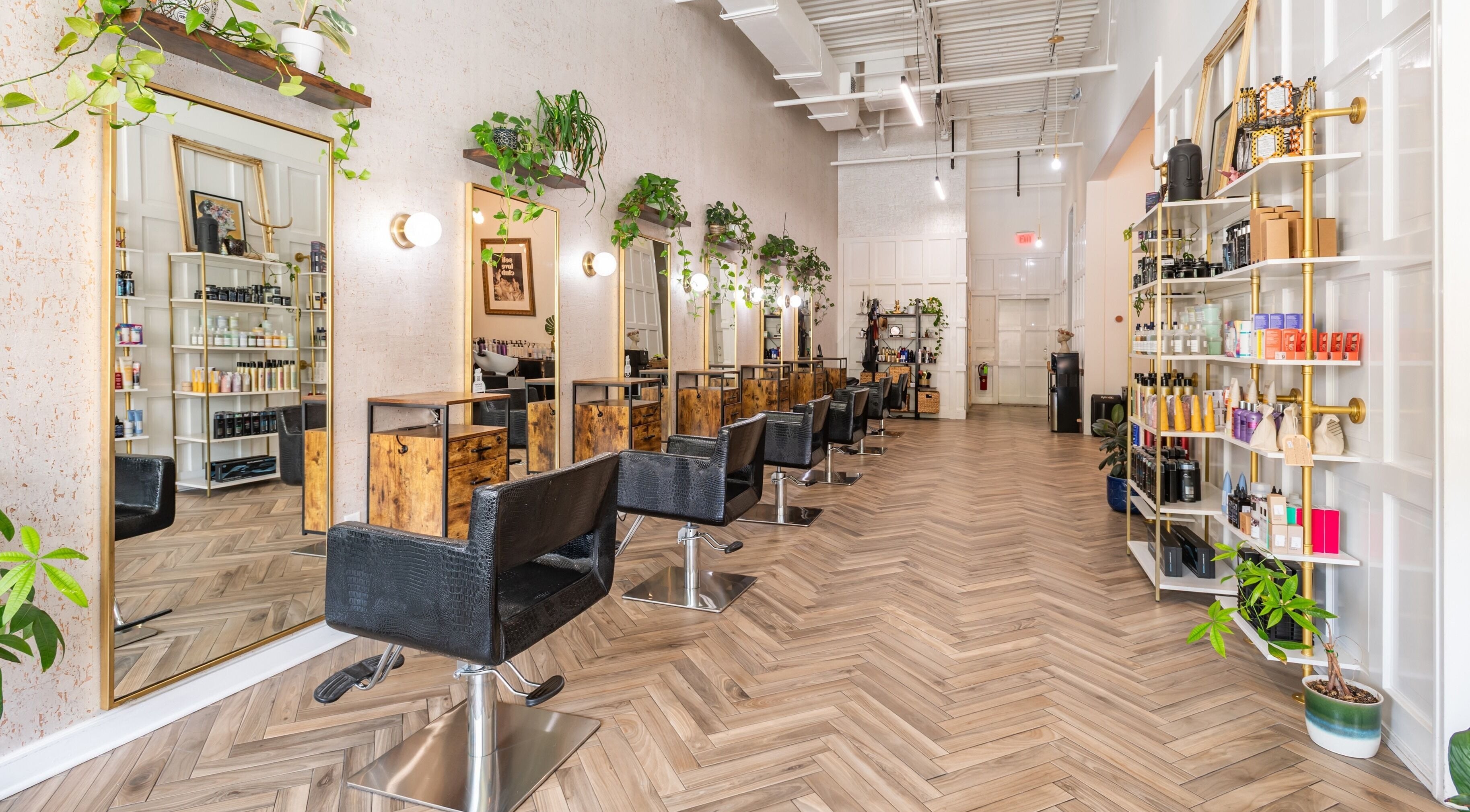 Interior of The Alma Project by AG in Boca Raton, Florida, US, featuring chic salon chairs and vibrant decor.