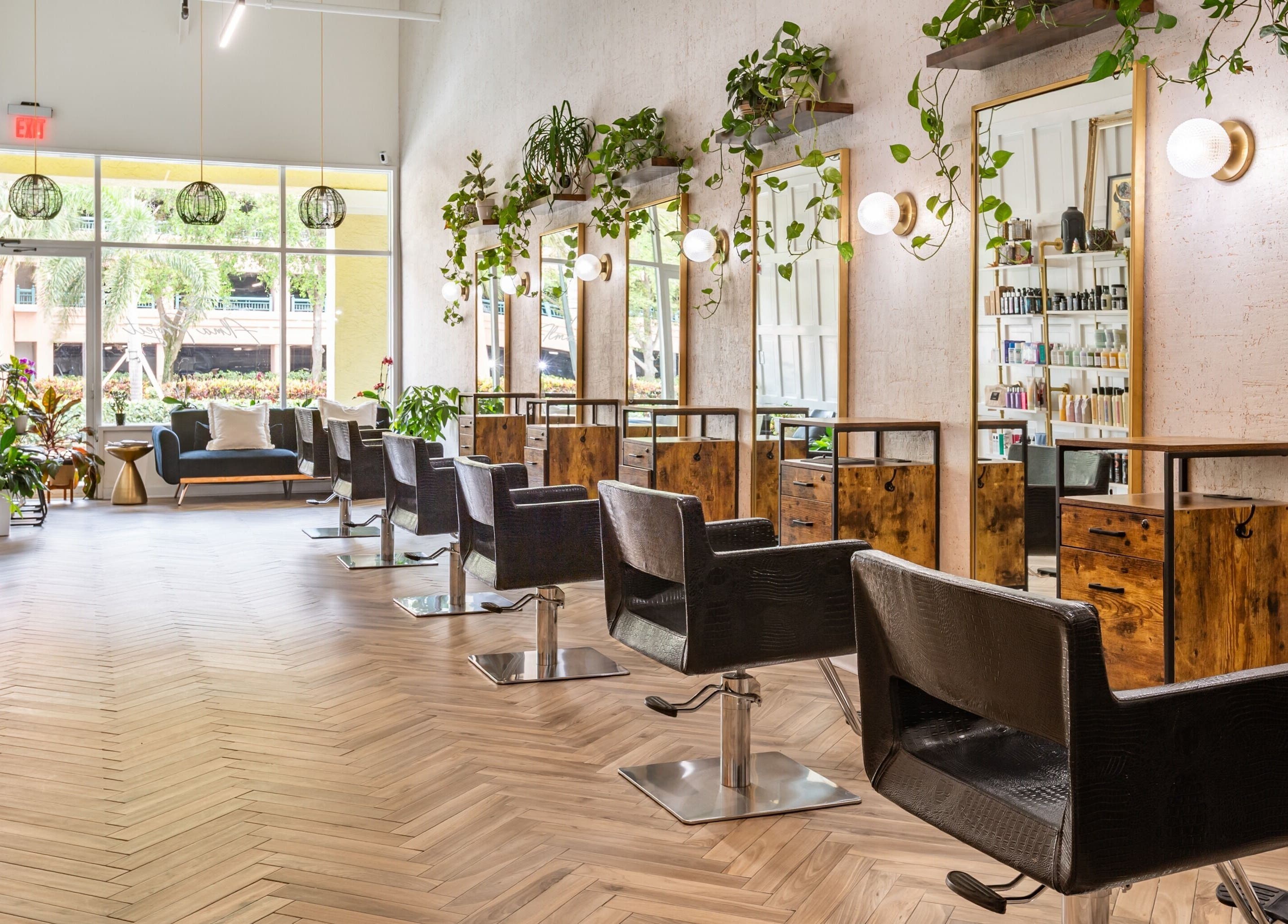 Chic interior of The Alma Project by AG in Boca Raton, Florida, US showcasing modern salon setup with sleek chairs.
